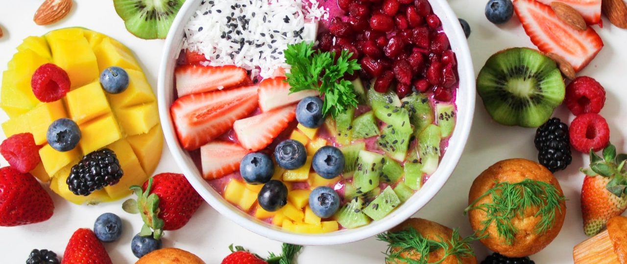 assorted sliced fruits in white ceramic bowl